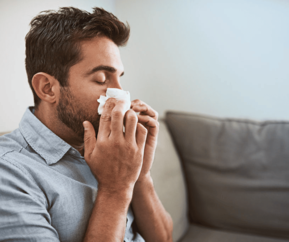 man blowing nose due to poor indoor air quality in south jersey home