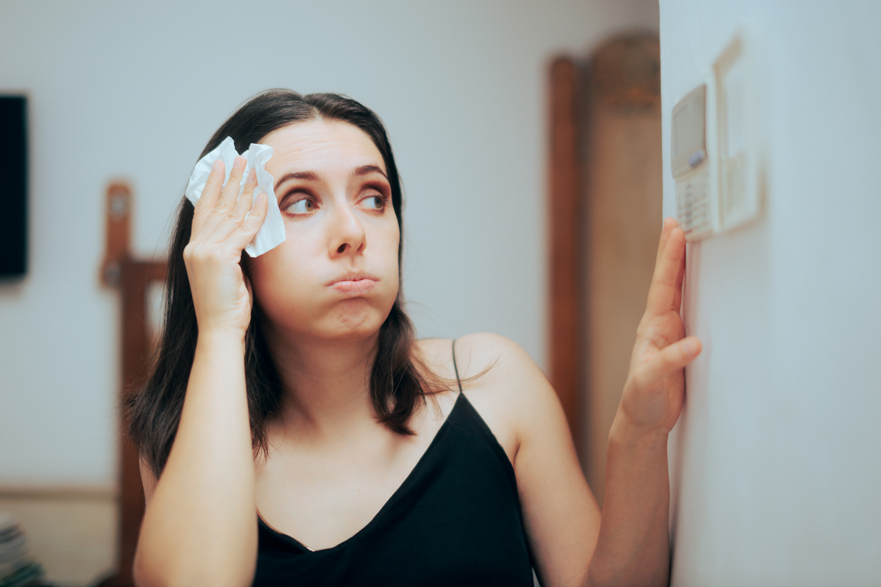 Woman feeling warm During Summer Setting Her Thermostat